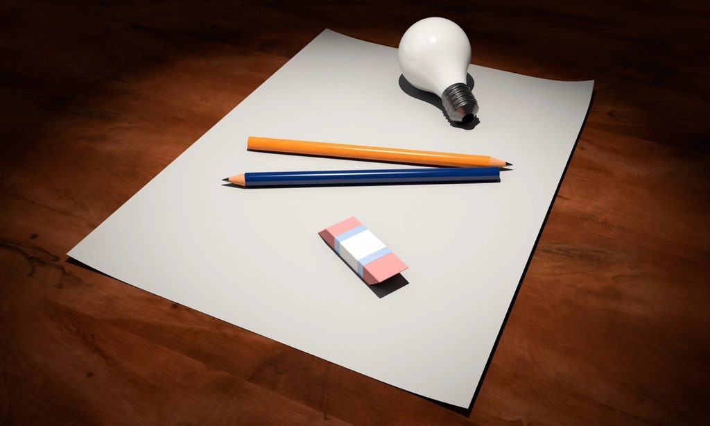A new business idea, notebook with lightbulb sketch